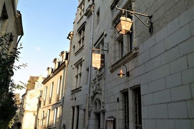 Low angle view of street light against building