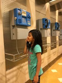 Girl using pay phone