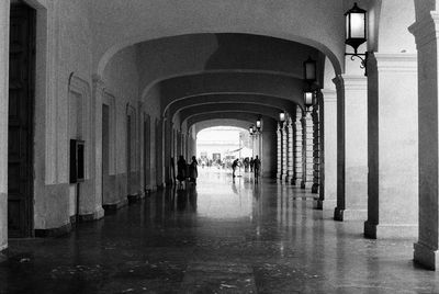 People walking in corridor of building