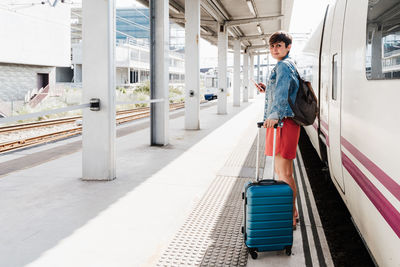 Full length of woman standing on railroad station platform