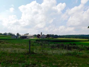 Houses on field against sky