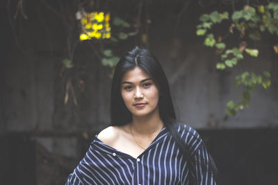 Portrait of young woman standing outdoors