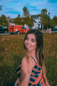 Portrait of smiling woman standing on field