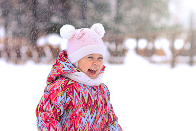 Portrait of smiling young woman wearing warm clothes