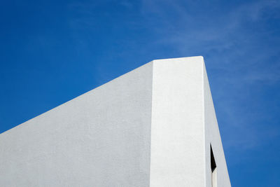 Low angle view of white building against blue sky