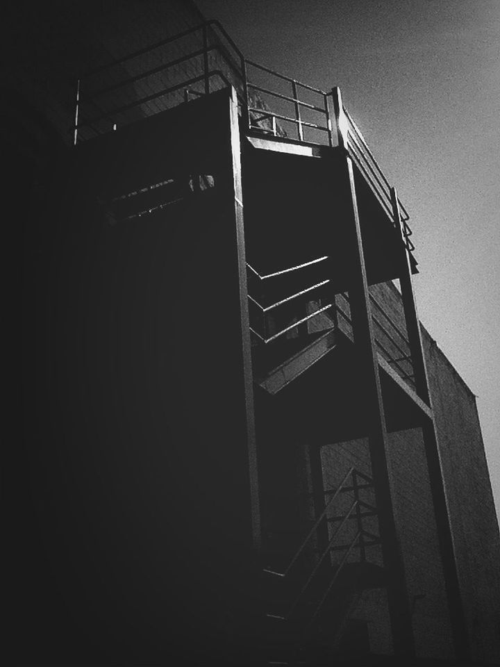 low angle view, built structure, technology, dark, architecture, old-fashioned, old, no people, copy space, building exterior, sky, abandoned, night, outdoors, silhouette, clear sky, obsolete, building, metal