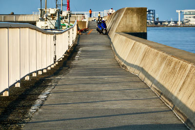 Pier amidst sea against sky