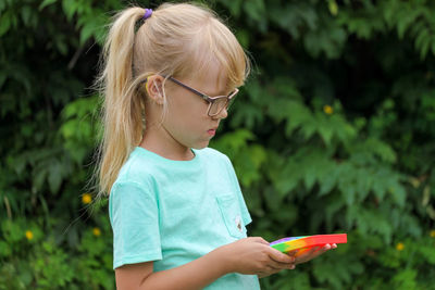 Child plays with toy anti-stress pop it