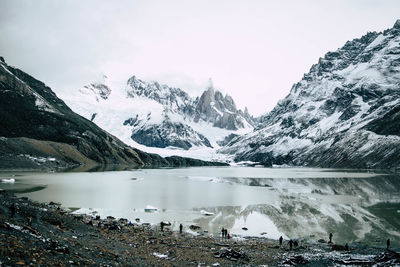 Glacial lake with snowcapped mountains in winter