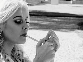 Close-up of young woman holding cigarette