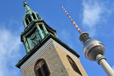 Low angle view of tower against cloudy sky