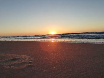 Scenic view of sea against clear sky during sunset