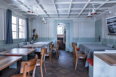 Chairs and tables arranged in elegant restaurant at luxurious resort