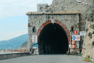 Information sign on road against sky