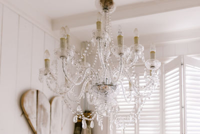 Low angle view of chandelier hanging on ceiling at home