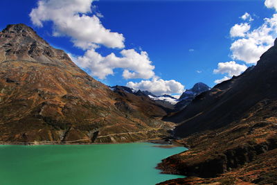 Scenic view of mountains against cloudy sky
