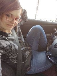 Midsection of teenage girl sitting in car
