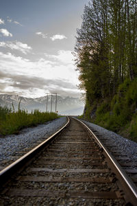 Surface level of railroad tracks against sky