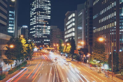 Illuminated city street and buildings at night