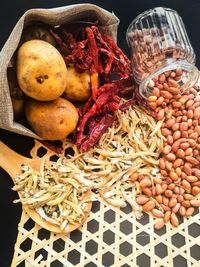 Raw potatoes and peanuts on table