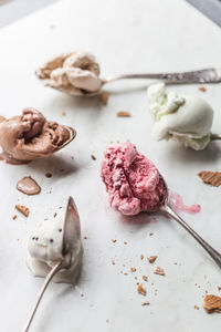 High angle view of spoons with ice cream on table