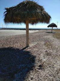 Palm trees on beach against clear blue sky