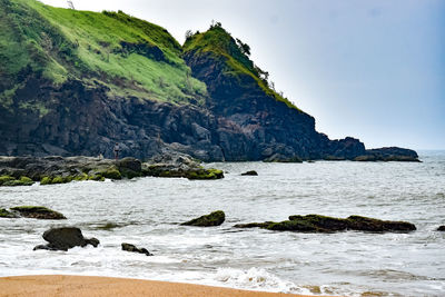 Scenic view of sea and mountains against sky