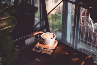 High angle view of coffee cup on table by window