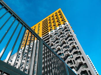Low angle view of modern building against clear blue sky