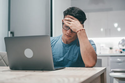 Young man using laptop at home