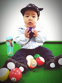 Boy playing with baby sitting on floor