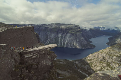 Tourists on troll tongue cliff landscape photo