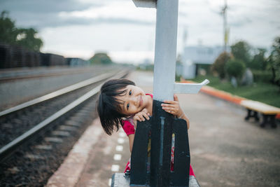 Full length of woman on railroad tracks