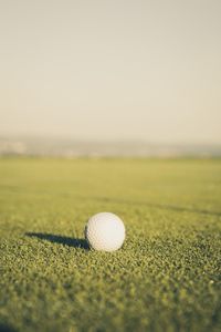 Close-up of golfball on field