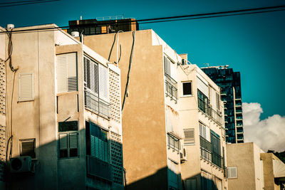 Low angle view of buildings against blue sky