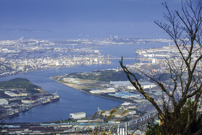 High angle view of city by sea against sky