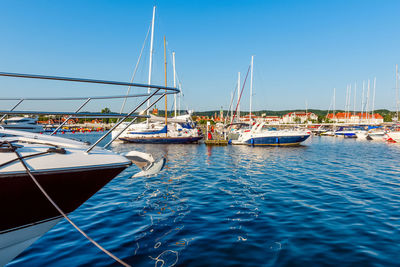 Sailing yachts moored on a pier in a harbour on baltic sea. nautical vessel for charter