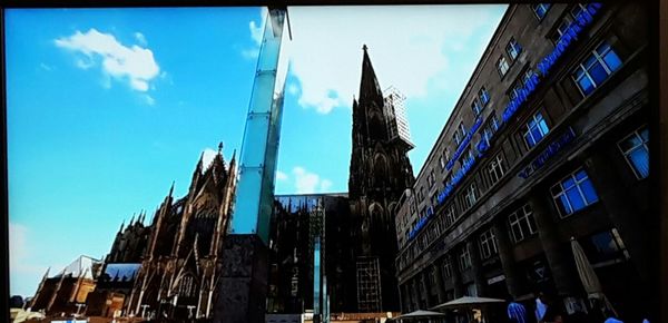 Low angle view of buildings against blue sky