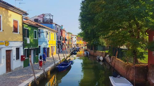 Canal amidst buildings against sky