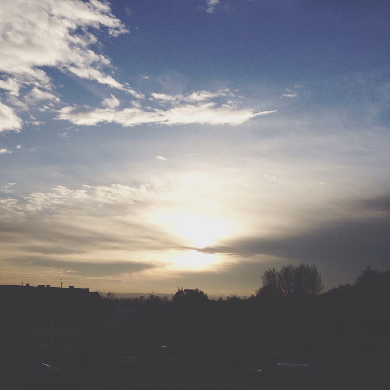 sunset, silhouette, sky, cloud - sky, sun, sunlight, beauty in nature, scenics, building exterior, nature, tree, sunbeam, tranquility, cloud, built structure, tranquil scene, architecture, outdoors, no people, orange color