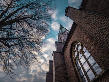 Low angle view of clock tower against sky