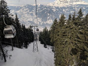 Overhead cable car against mountain during winter