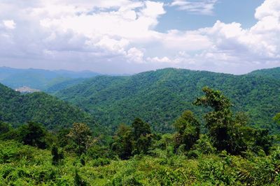 Scenic view of mountains against cloudy sky