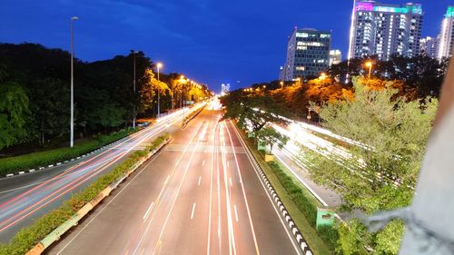 High angle view of light trails on road in city