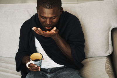 Young man sitting on sofa