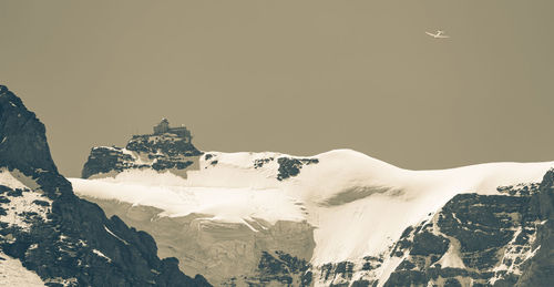 Scenic view of snowcapped mountains against clear sky