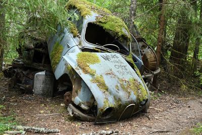 Close-up of abandoned vehicle on field