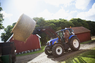 Tractor on agricultural field against sky