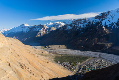 Scenic view of snowcapped mountains against blue sky