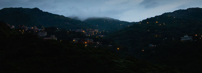 Scenic view of mountains against sky at night